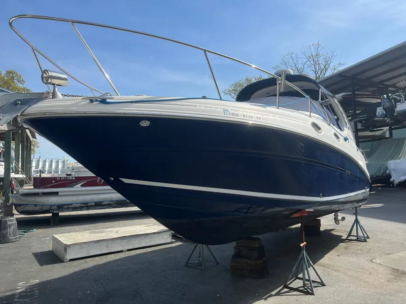 Slide: The Image of 2005 Sea Ray 280 Sundancer boat on stands in a marina setting. - 2