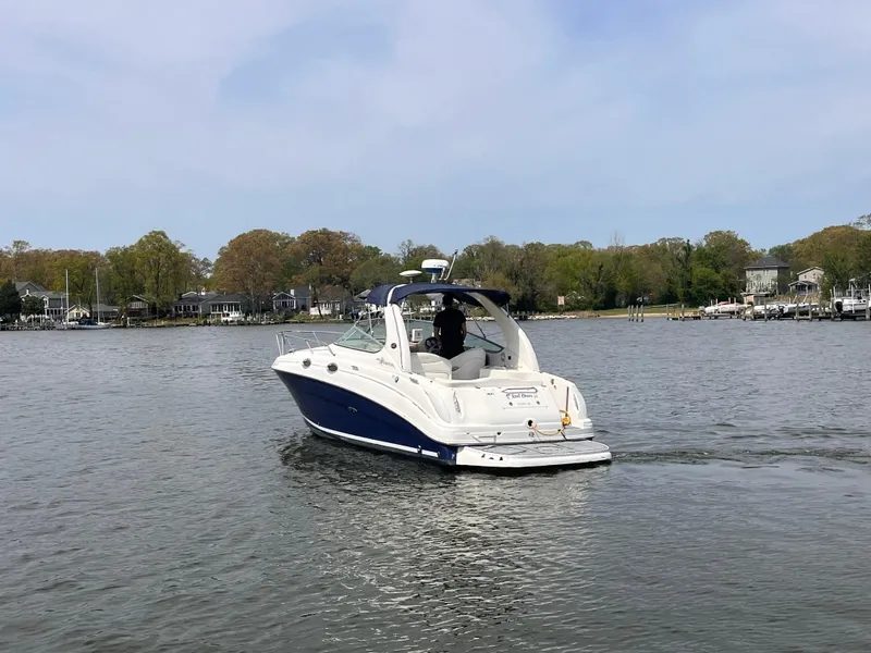 Slide: The Image of 2005 Sea Ray 280 Sundancer cruising on a calm lake with scenic shoreline. - 3