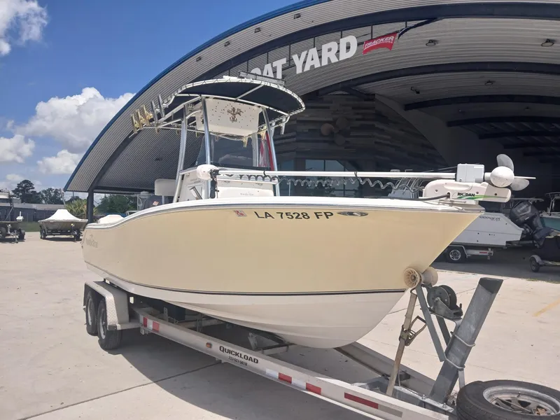 Slide: The Image of 2007 NauticStar 22 CC OS boat on trailer at dealership, sunny day. - 10