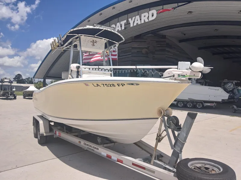 Slide: The Image of 2007 NauticStar 22 CC OS boat on trailer at a boat yard under a clear sky. - 4