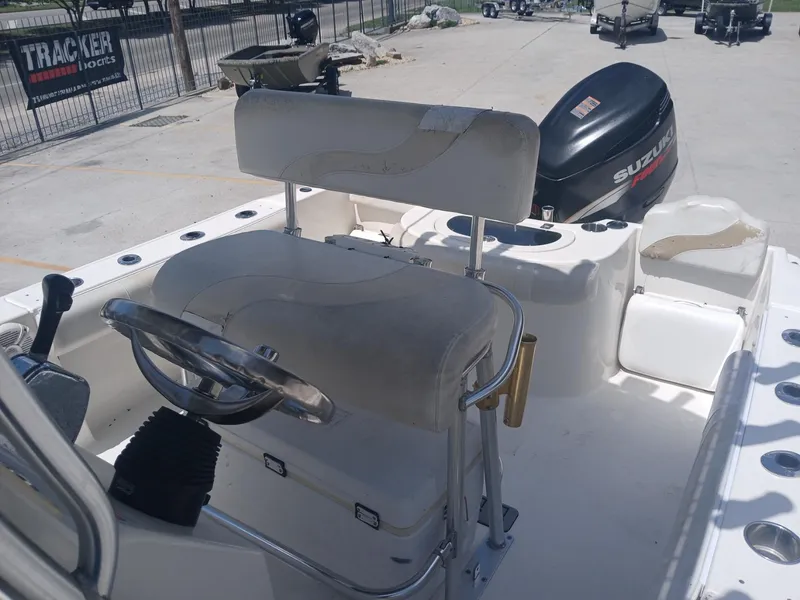 Slide: The Image of 2007 NauticStar 22 CC OS boat interior with steering wheel and Suzuki outboard motor. - 7