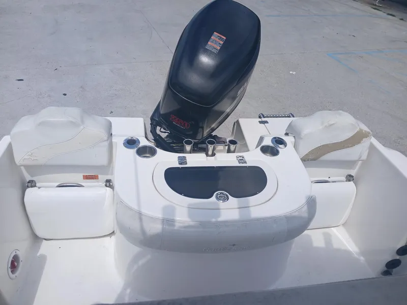 Slide: The Image of 2007 NauticStar 22 CC OS boat interior with engine and seating. - 8