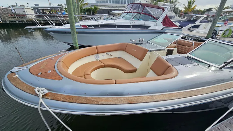 Slide: The Image of 2013 Chris-Craft Launch 32 boat with elegant seating, docked in a marina. - 10