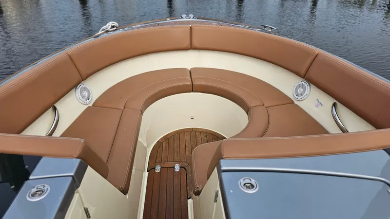 Slide: The Image of 2013 Chris-Craft Launch 32 boat with tan leather seating and wooden deck. - 12
