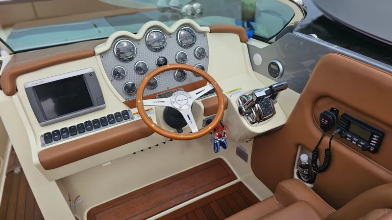 Slide: The Image of 2013 Chris-Craft Launch 32 dashboard with wood accents and modern controls. - 17