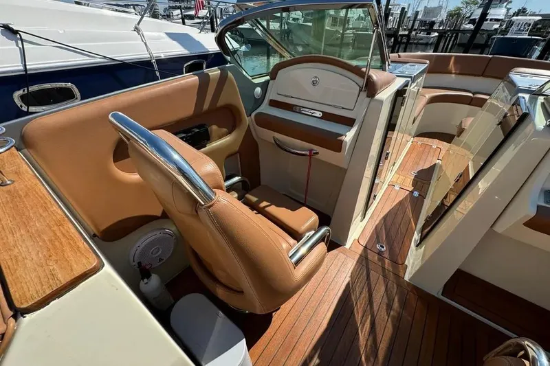 Slide: The Image of 2013 Chris-Craft Launch 32 interior with tan leather seats and wooden flooring. - 20