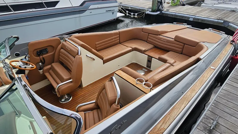 Slide: The Image of 2013 Chris-Craft Launch 32 boat with luxurious tan leather seating and wooden deck. - 7