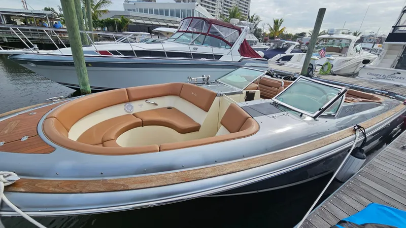 Slide: The Image of 2013 Chris-Craft Launch 32 boat docked, featuring elegant seating and sleek design. - 9