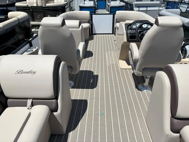 Slide: The Image of 2025 Bentley Pontoons Legacy 223 Navigator interior with luxurious seating and modern dashboard. - 1