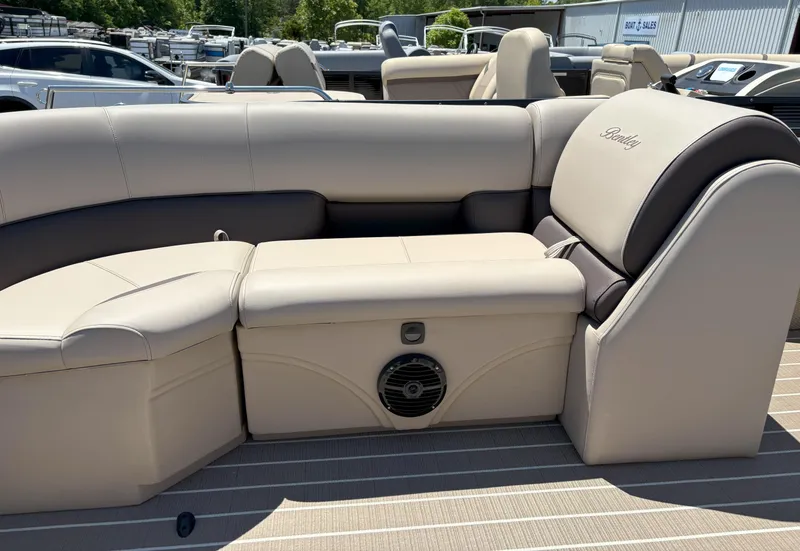 Slide: The Image of 2025 Bentley Pontoons Legacy 223 Navigator interior seating with beige upholstery and speaker. - 10