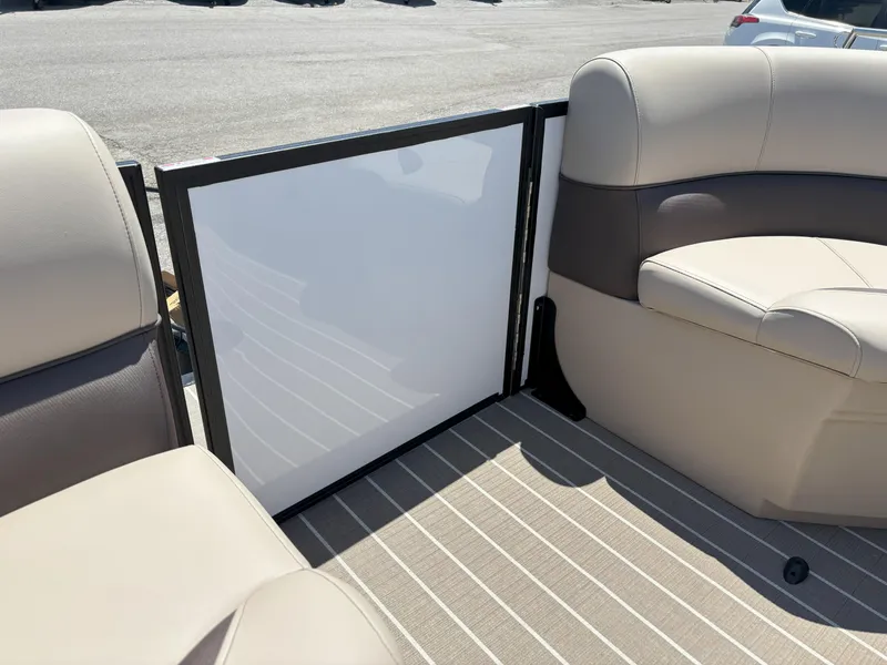 Slide: The Image of 2025 Bentley Pontoons Legacy 223 Navigator interior seating with beige upholstery and striped flooring. - 11
