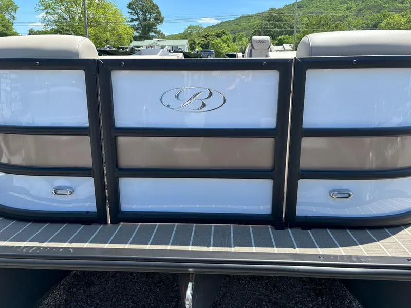 Slide: The Image of 2025 Bentley Pontoons Legacy 223 Navigator rear view with logo, outdoors. - 16