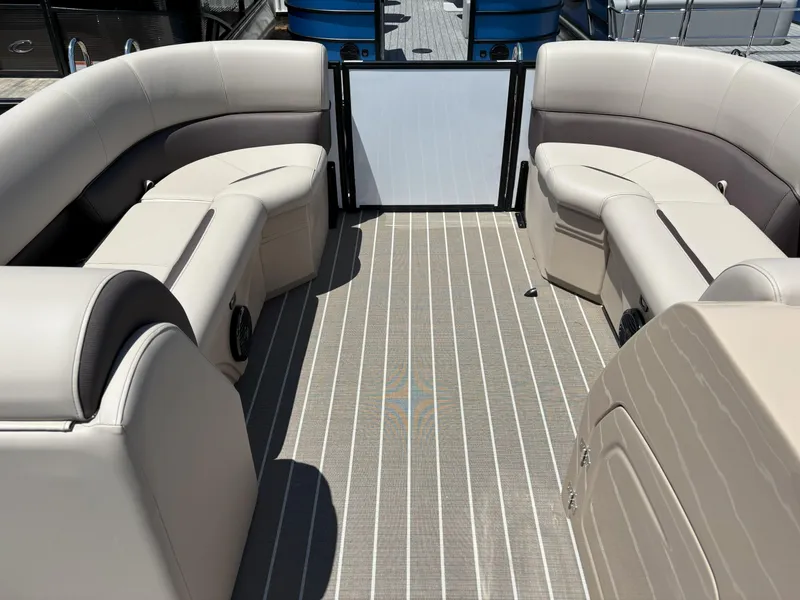 Slide: The Image of 2025 Bentley Pontoons Legacy 223 Navigator interior with beige seating and striped flooring. - 17