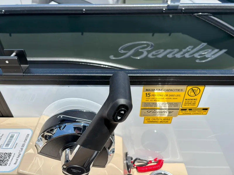 Slide: The Image of 2025 Bentley Pontoons Legacy 223 Navigator control panel with throttle and capacity warnings. - 20