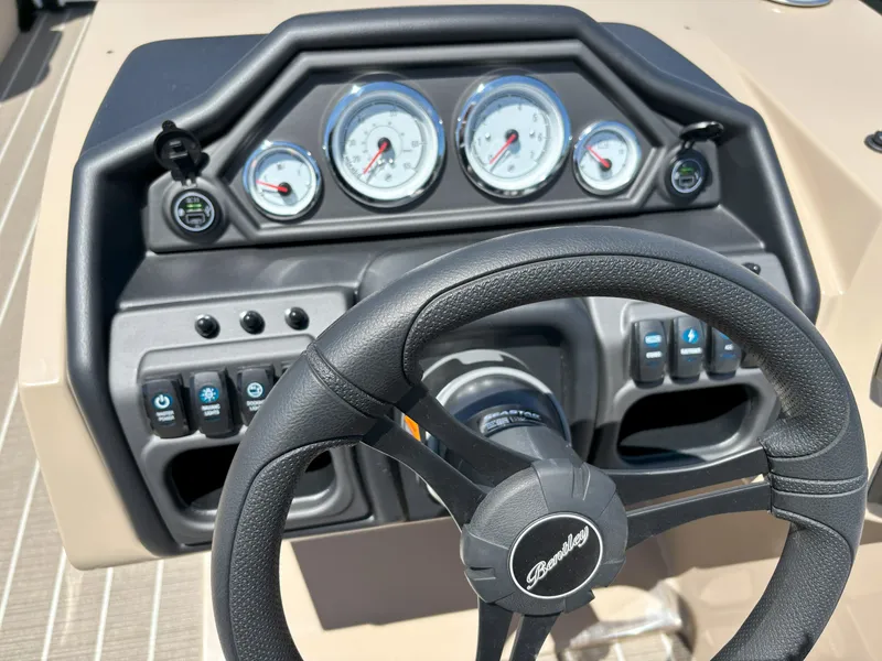 Slide: The Image of 2025 Bentley Pontoons Legacy 223 Navigator dashboard with steering wheel and gauges. - 6