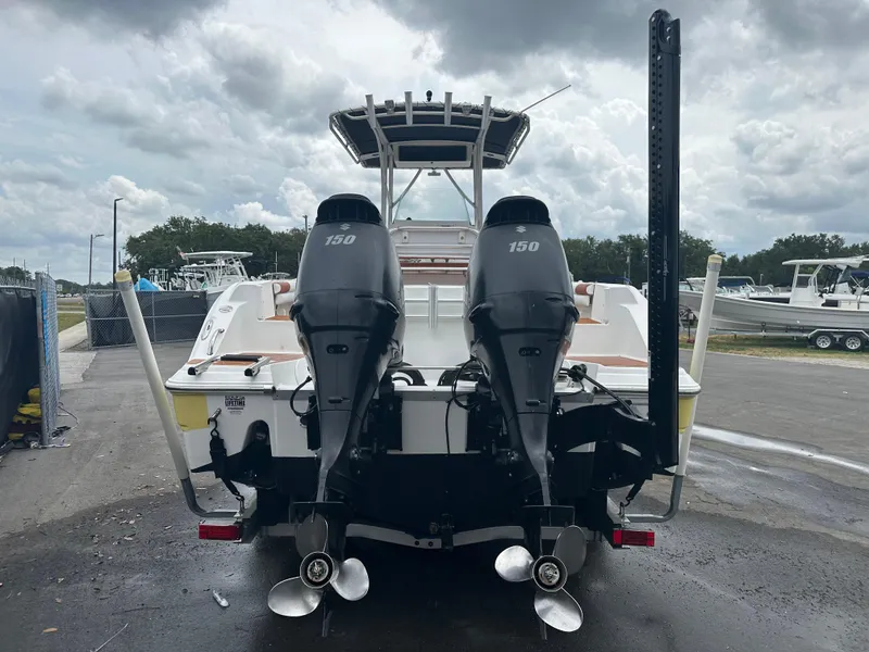 Slide: The Image of 2007 Sea Fox 256 CC boat with dual 150 horsepower engines, docked under cloudy skies. - 10