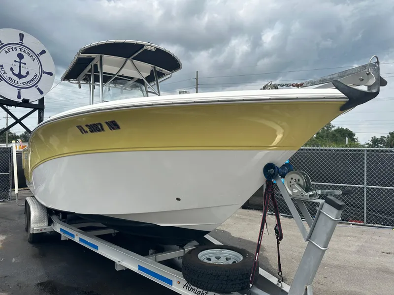 Slide: The Image of 2007 Sea Fox 256 CC boat on trailer, yellow and white hull, overcast sky. - 15