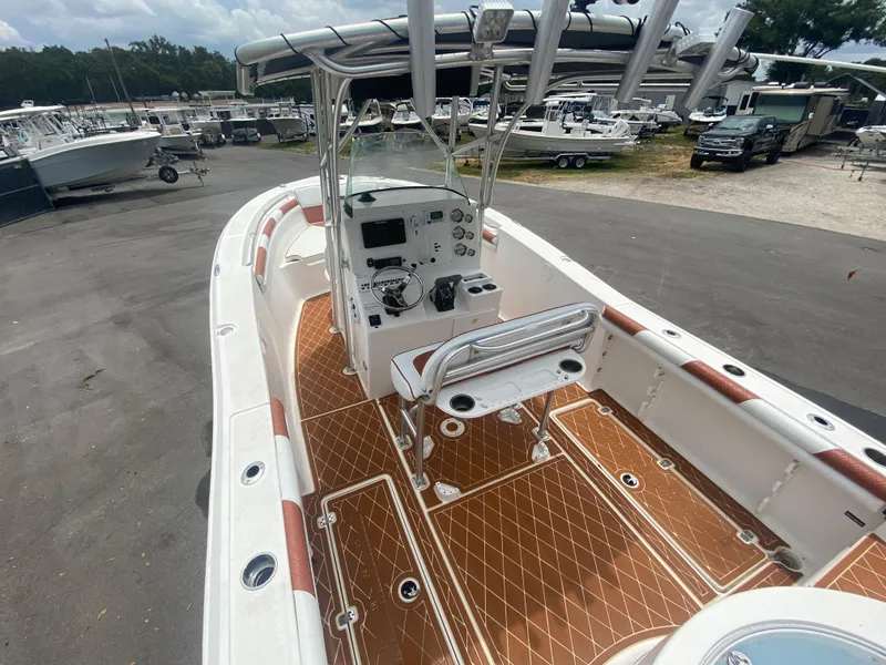 Slide: The Image of 2007 Sea Fox 256 CC boat with center console and spacious deck, parked outdoors. - 18