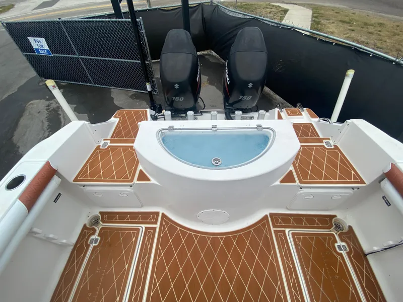 Slide: The Image of 2007 Sea Fox 256 CC boat deck with twin outboard motors and teak flooring. - 19