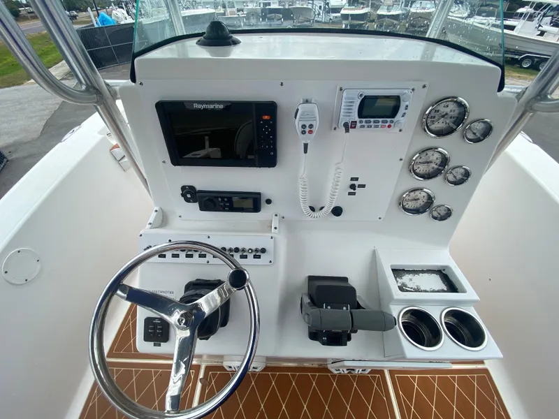 Slide: The Image of 2007 Sea Fox 256 CC boat dashboard with steering wheel, controls, and navigation instruments. - 22