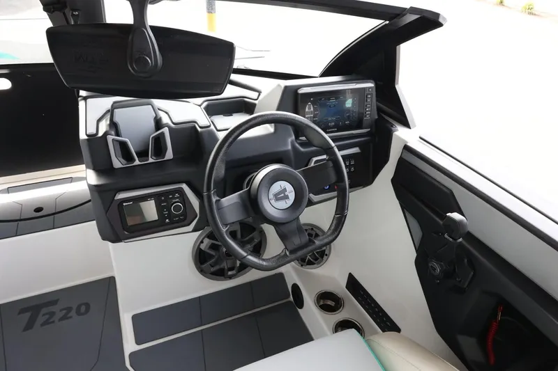 Slide: The Image of 2023 Axis T220 boat interior with modern dashboard and steering wheel. - 14