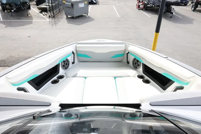 Slide: The Image of 2023 Axis T220 boat interior with white seating and teal accents. - 16