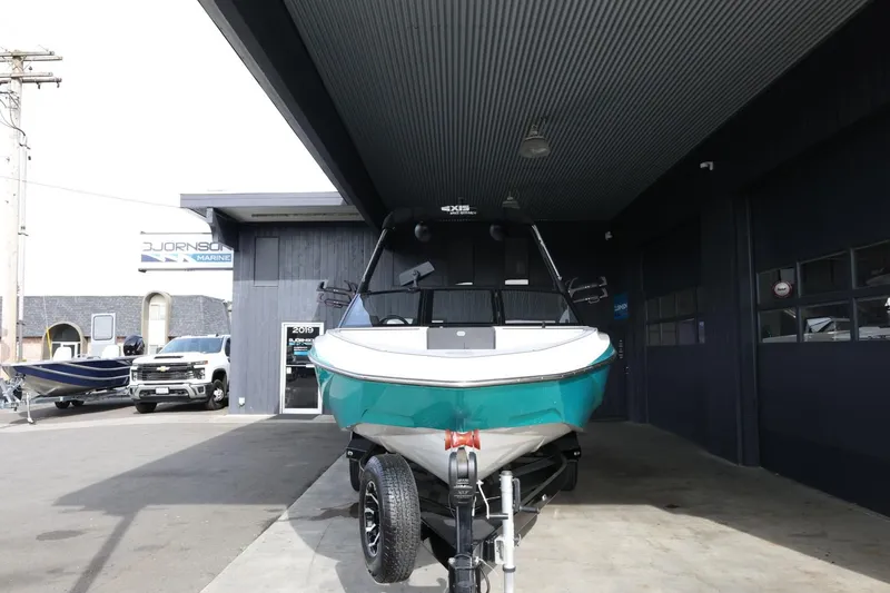 Slide: The Image of 2023 Axis T220 boat on trailer at dealership, front view. - 3