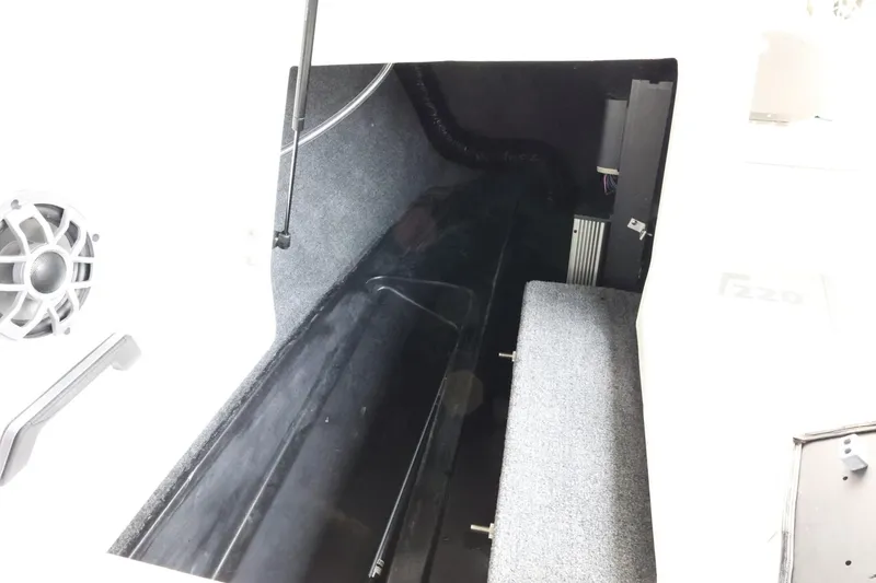 Slide: The Image of 2023 Axis T220 boat interior storage compartment with speaker and seating. - 32