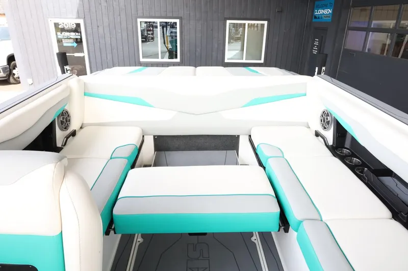Slide: The Image of 2023 Axis T220 boat interior with white and teal seating, modern design. - 37