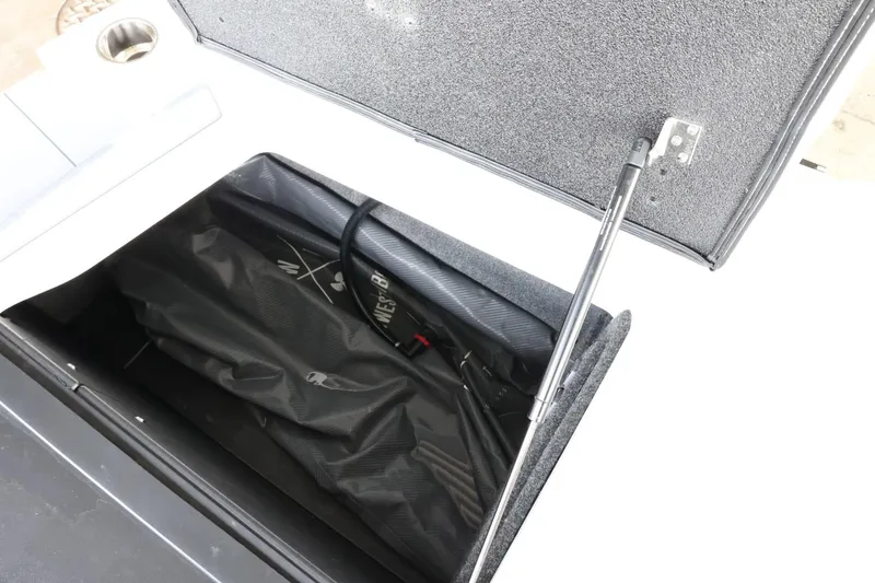 Slide: The Image of 2023 Axis T220 boat storage compartment with open lid and visible interior. - 39