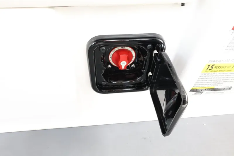 Slide: The Image of 2023 Axis T220 boat fuel cap with open cover, showcasing red valve. - 41