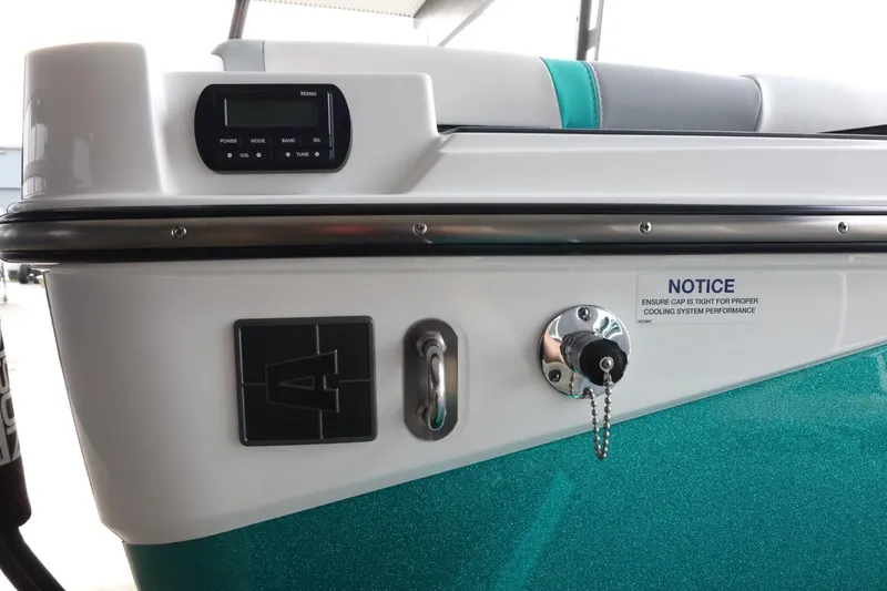 Slide: The Image of 2023 Axis T220 boat interior with control panel and teal upholstery. - 45