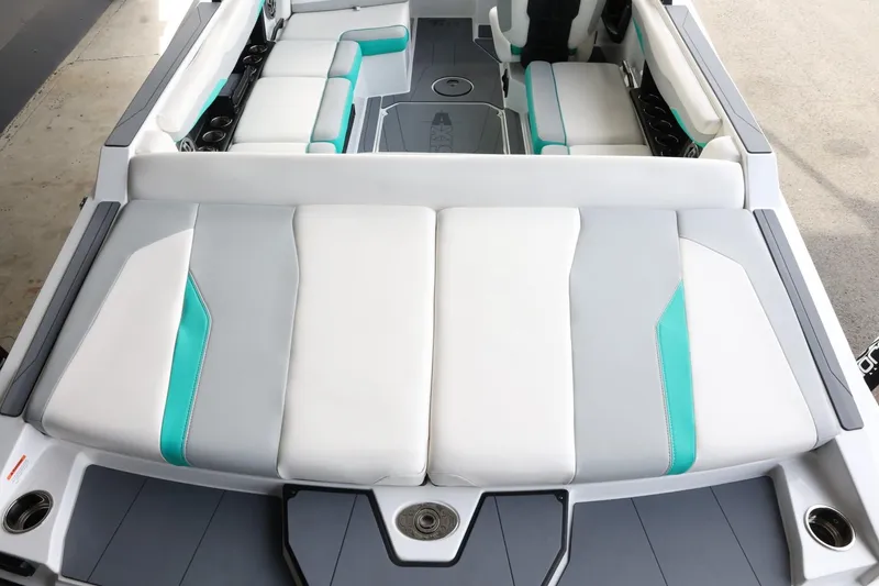 Slide: The Image of 2023 Axis T220 boat interior with white and teal seating, showcasing modern design and comfort. - 9