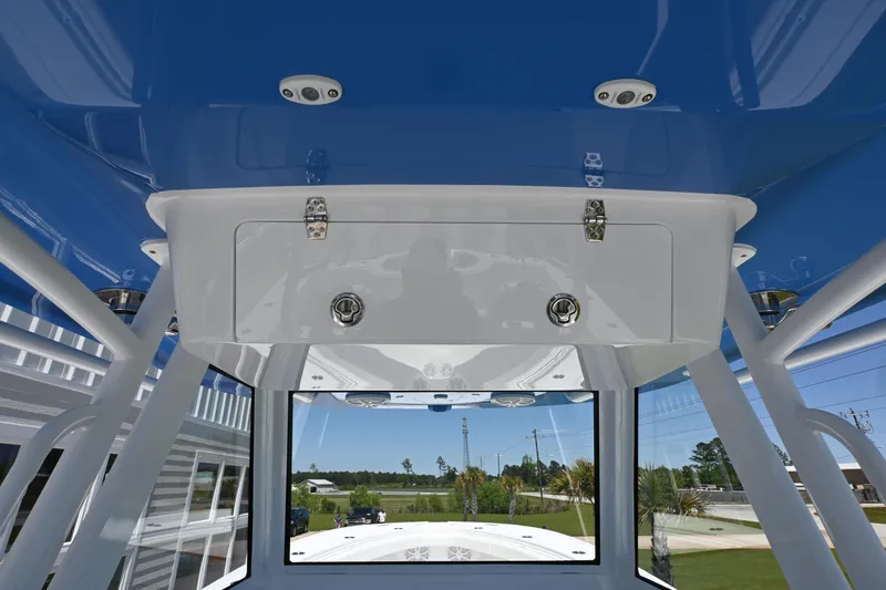 Slide: The Image of 2022 Onslow Bay 41 boat interior with blue ceiling and storage compartment. - 13