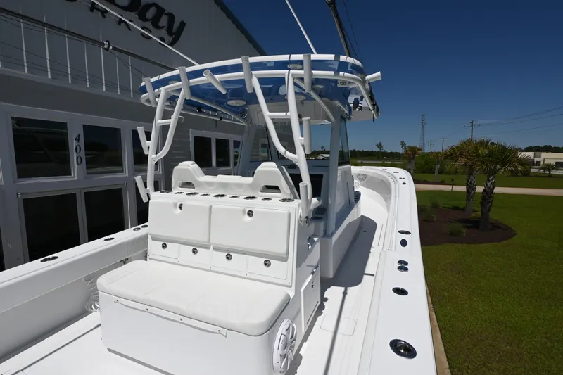 Slide: The Image of 2022 Onslow Bay 41 boat with white seating and canopy, displayed outdoors. - 14