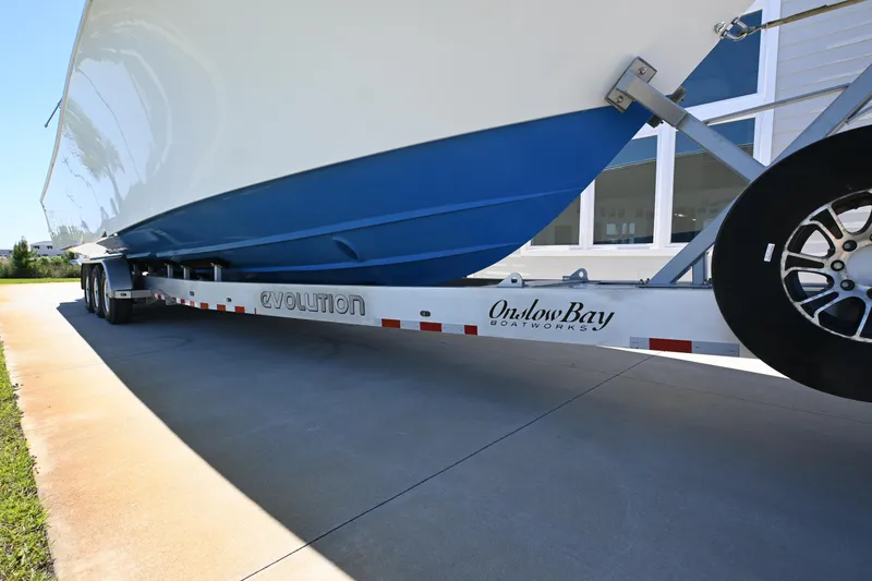 Slide: The Image of 2022 Onslow Bay 41 boat on trailer, side view, showcasing hull and trailer details. - 16