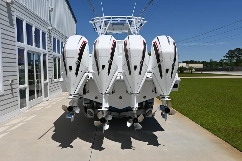 Slide: The Image of 2022 Onslow Bay 41 boat with four powerful outboard engines, parked outdoors. - 3