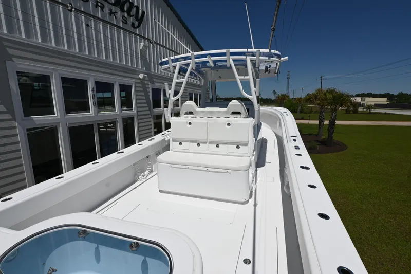 Slide: The Image of 2022 Onslow Bay 41 boat with spacious deck and seating, displayed outdoors. - 4