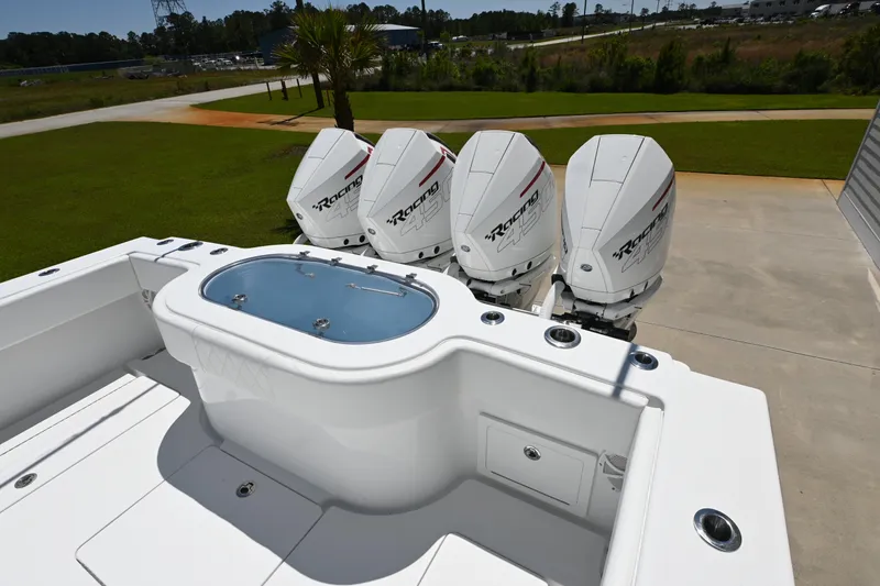 Slide: The Image of 2022 Onslow Bay 41 boat with four powerful outboard engines, docked on a sunny day. - 8