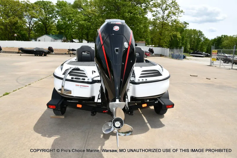 Slide: The Image of 2024 Nitro Z20 Pro boat with powerful outboard motor, parked on concrete lot. - 26