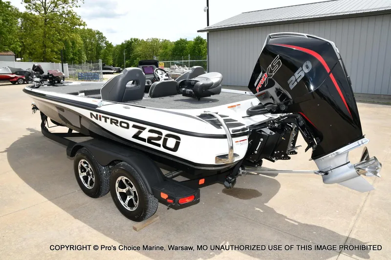 Slide: The Image of 2024 Nitro Z20 Pro boat with powerful 250 engine, parked on a trailer. - 27