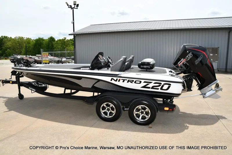 Slide: The Image of 2024 Nitro Z20 Pro boat with Mercury engine on trailer, parked outdoors. - 28