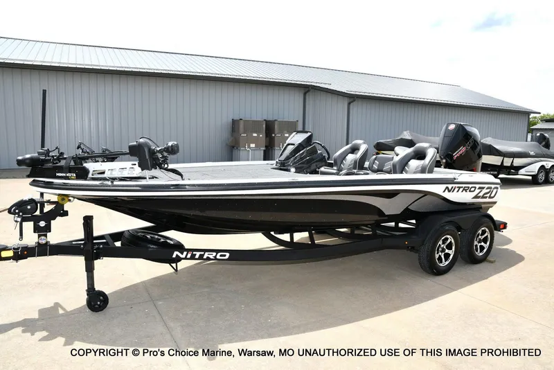 Slide: The Image of 2024 Nitro Z20 Pro fishing boat on trailer, parked outside a metal building. - 29
