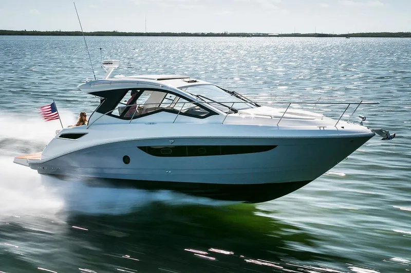 Slide: The Image of 2017 Sea Ray 350 Coupe cruising on open water, showcasing sleek design and performance. - 1