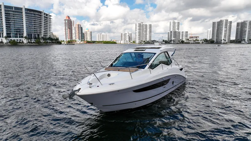 Slide: The Image of 2017 Sea Ray 350 Coupe on water with city skyline in background. - 4