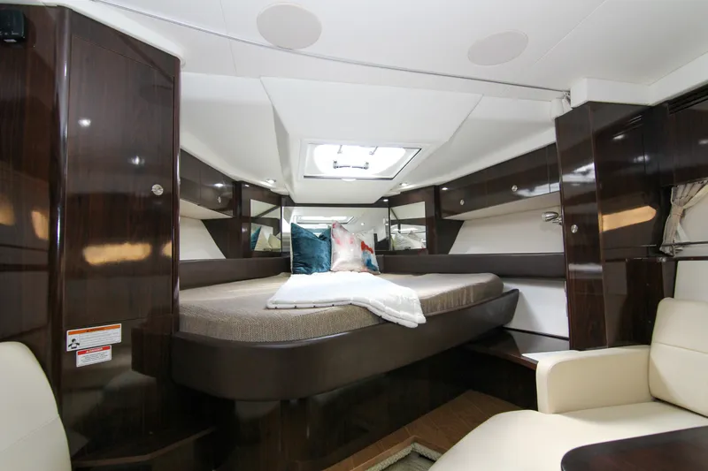Slide: The Image of Luxurious interior of 2017 Sea Ray 350 Coupe with elegant wood finishes and cozy bedding. - 7