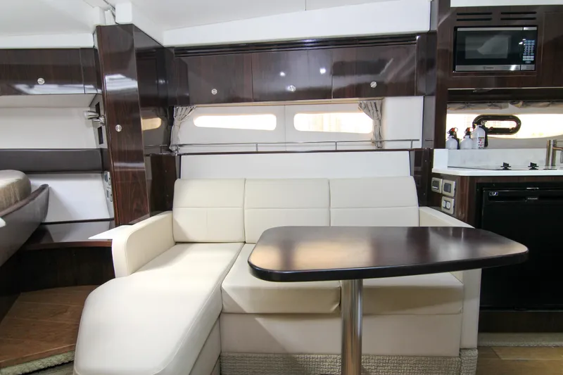 Slide: The Image of Interior of 2017 Sea Ray 350 Coupe with modern seating and kitchenette. - 8