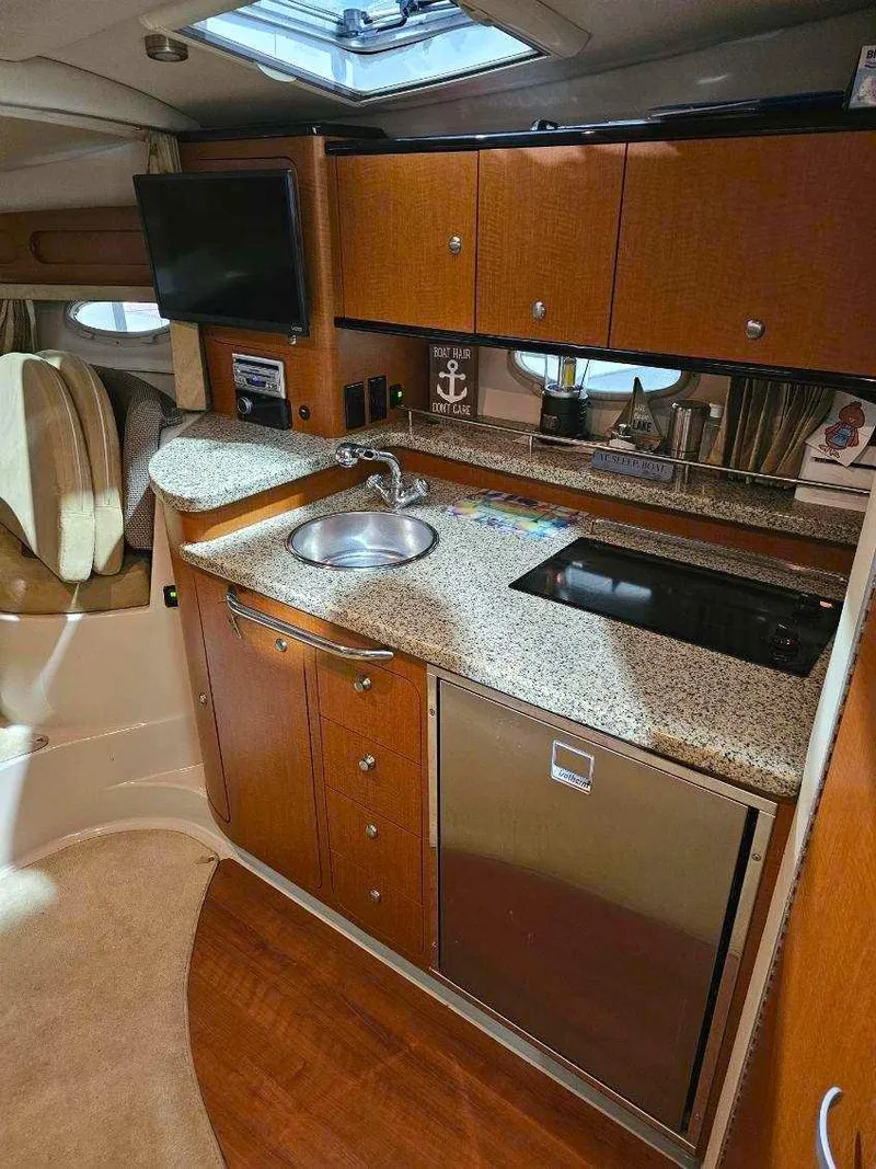 Slide: The Image of 2005 Chaparral Signature 330 yacht interior with modern kitchen and wood cabinetry. - 12
