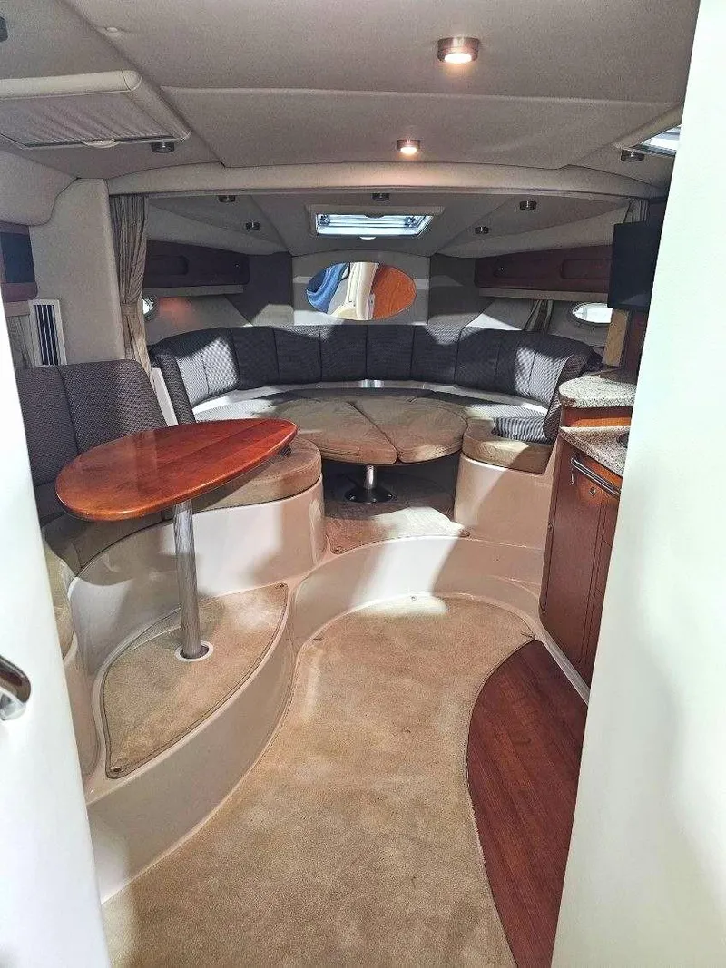 Slide: The Image of 2005 Chaparral Signature 330 interior with seating, table, and modern amenities. - 15
