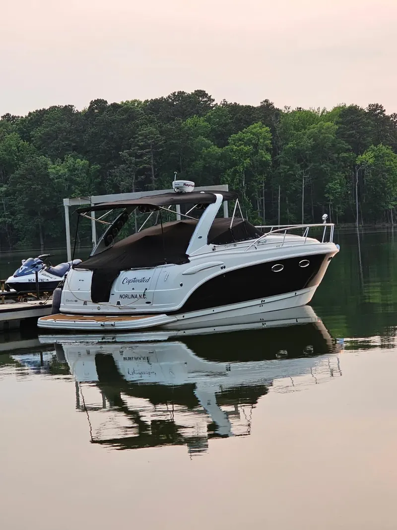 Slide: The Image of 2005 Chaparral Signature 330 boat docked on calm lake with forest backdrop. - 4